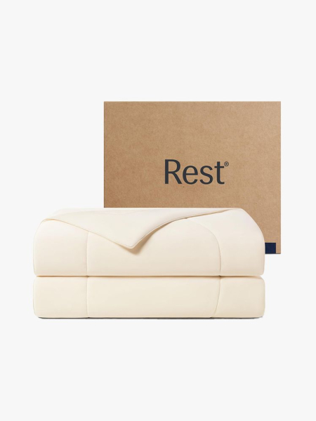 Rest Evercool Cooling Comforter folded beige comforter and cardboard box on light gray background